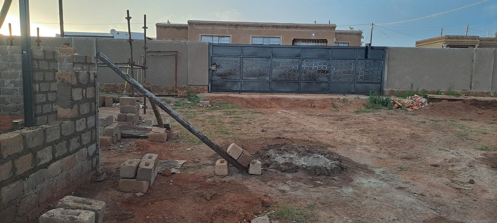 Black sliding gate with patterned steel infill