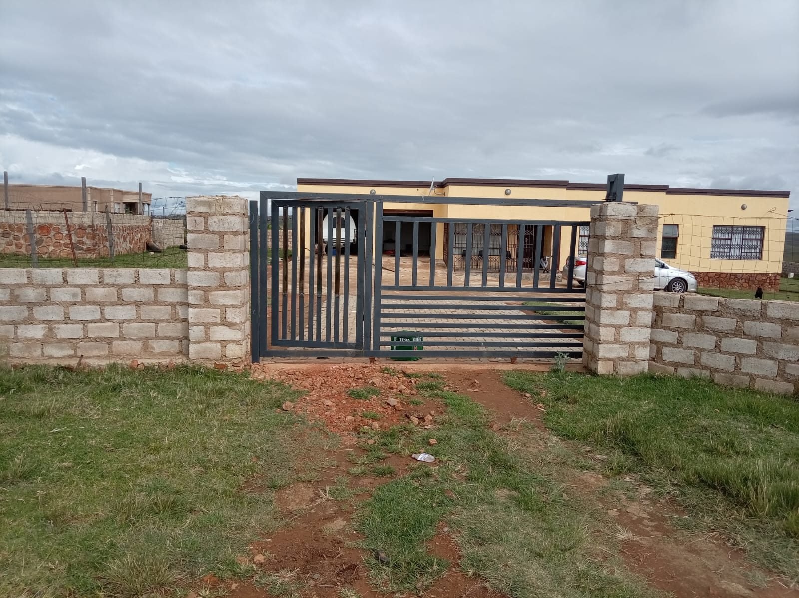 Sliding driveway gate with pedestrian gate installed